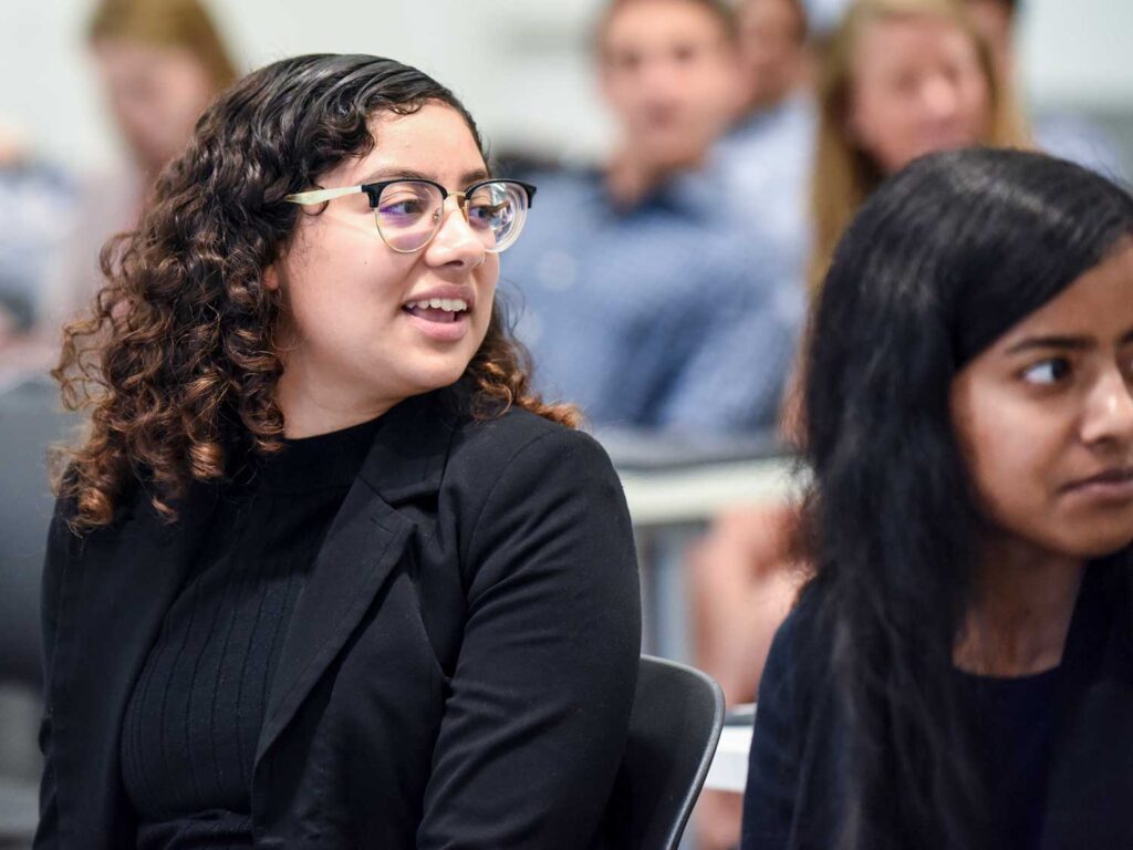 Two female students in class staring to their right.