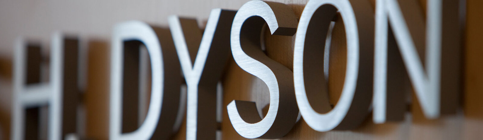 Metal letters spelling “Dyson.”